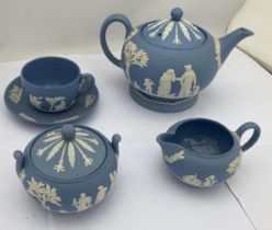 A WEDGWOOD PALE BLUE JASPERWARE TEA FOR ONE BACHELOR SET COMPRISING TEAPOT, SUGAR BOWL, CREAM JUG