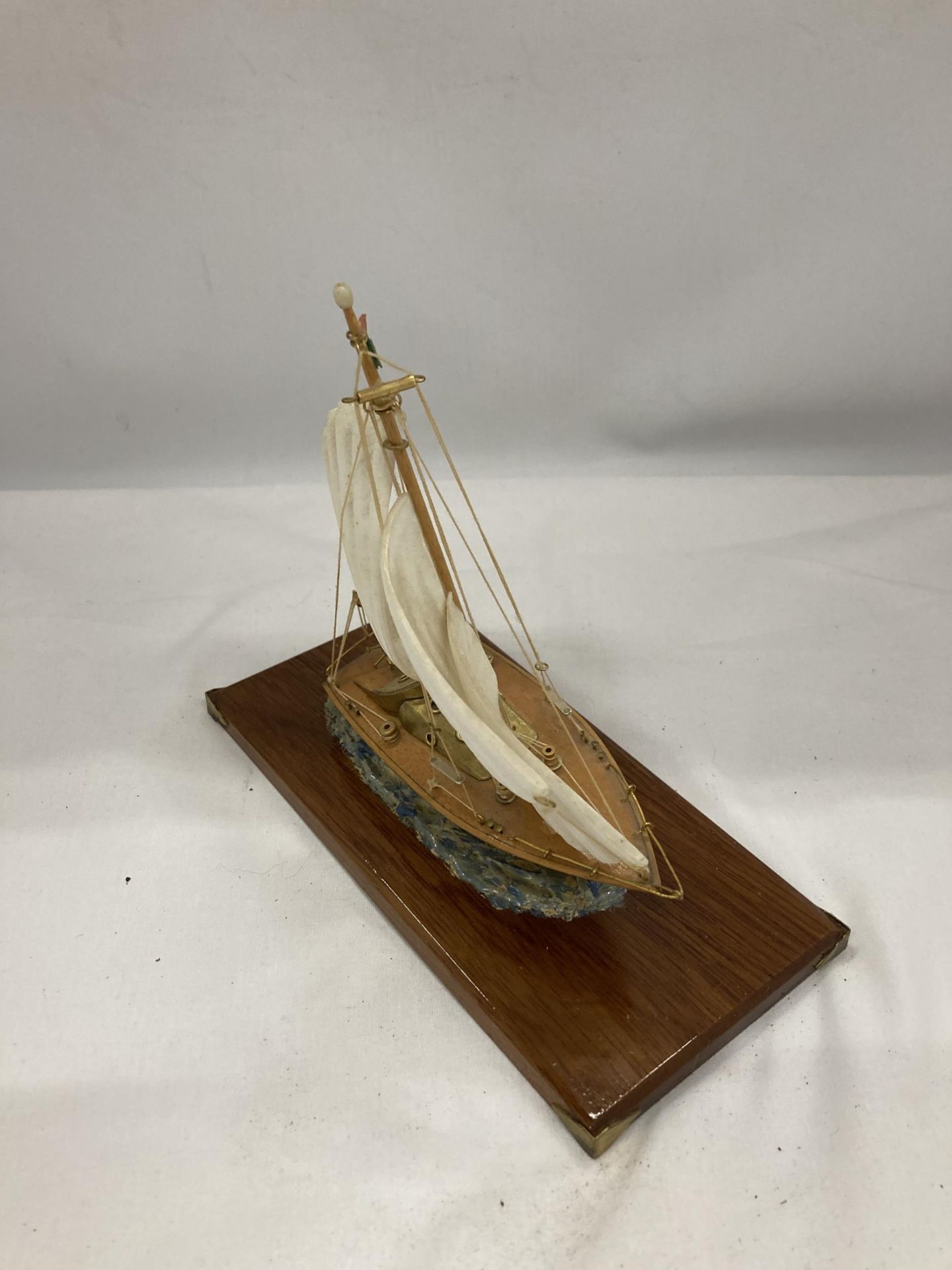 A MODEL OF A VINTAGE ITALIAN YACHT, ON A WOODEN PLINTH, WITH ENAMEL AND BRASS HULL, HEIGHT APPROX - Image 2 of 2