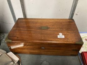 A MAHOGANY WRITING SLOPE WITH BRASS CORNERS AND ESCUTCHEON - IN NEED OF RESTORATION