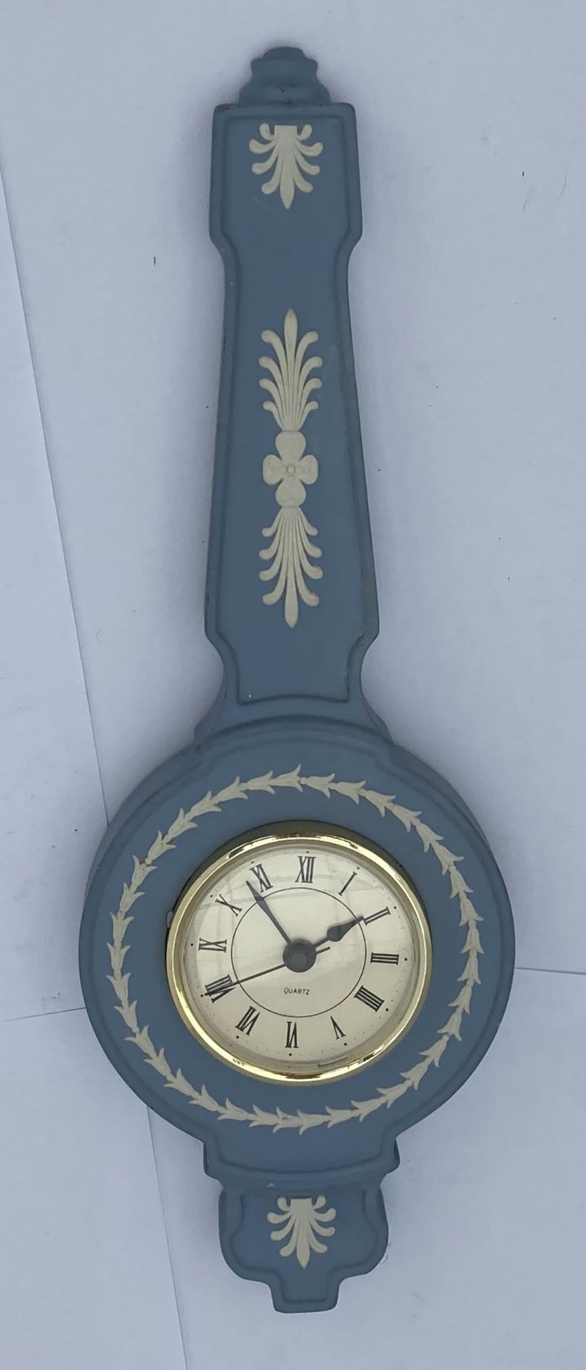 A WEDGWOOD PALE BLUE JASPERWARE CLOCK IN THE FORM OF A BAROMETER