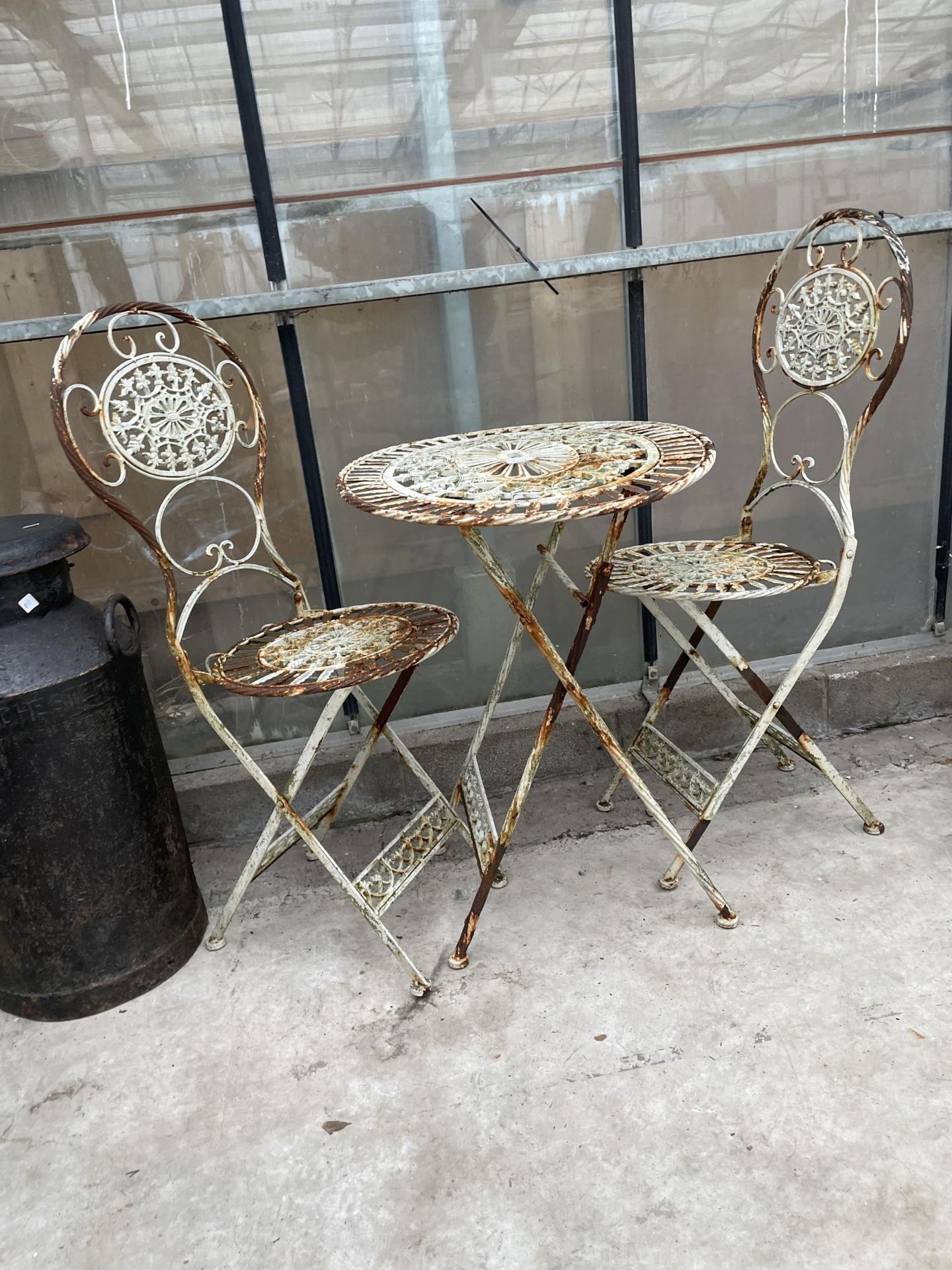 A VINTAGE FOLDING METAL BISTRO TABLE AND TWO CHAIRS - Image 2 of 2