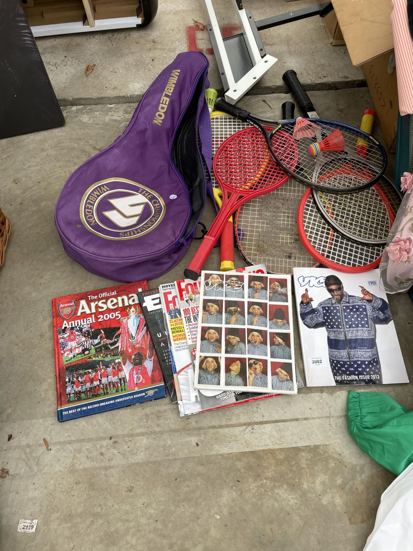 AN ASSORTMENT OF SPORTS MAGAZINES AND TENNIS RACKETS ETC