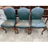 A SET OF THREE MAHOGANY DINING CHAIRS ON FRONT CABRIOLE LEGS, WITH LEATHER STUDDED SEATS AND BACKS