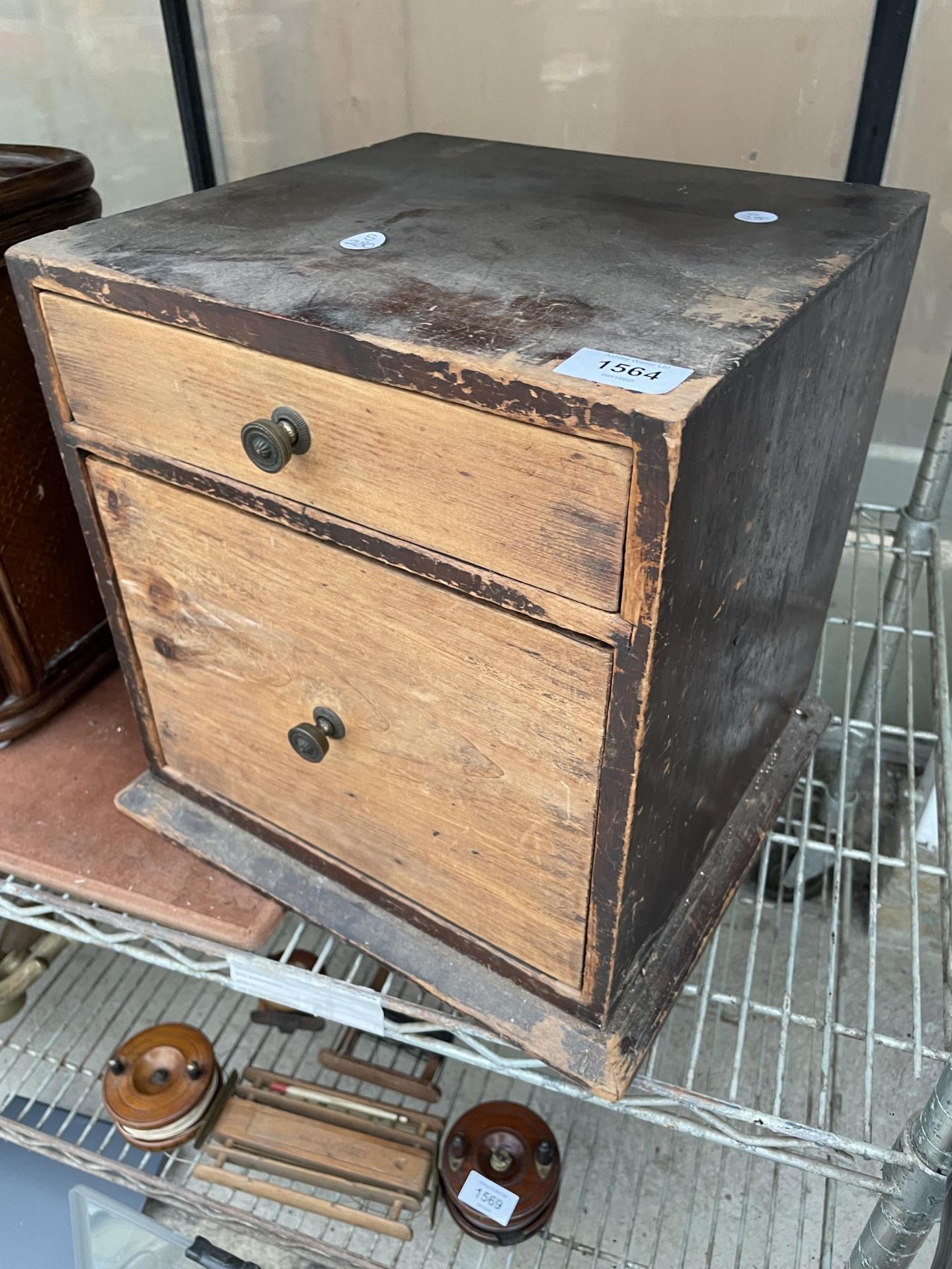 A VINTAGE WOODEN CHEST OF TWO DRAWERS