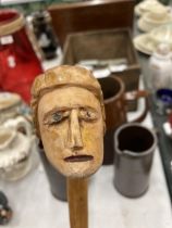 A CARVED WOODEN HEAD WALKING STICK