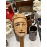 A CARVED WOODEN HEAD WALKING STICK