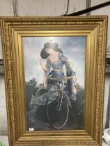 A LARGE PRINT OF A LADY ON A BICYCLE IN AN ORNATE GILT FRAME, 76CM X 103CM