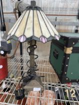A HEAVY METAL TABLE LAMP WITH TIFFANY STYLE SHADE