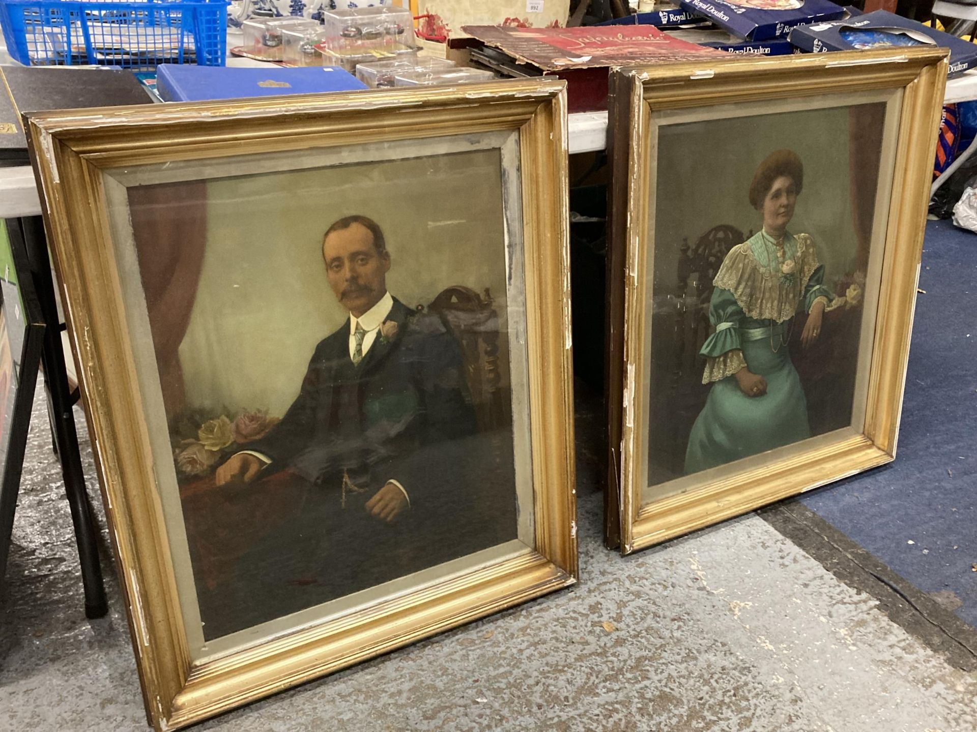 A PAIR OF HAND TINTED EDWARDIAN PORTRAITS OF AN EDWARDIAN COUPLE IN GILT FRAMES - 67CM X 79CM