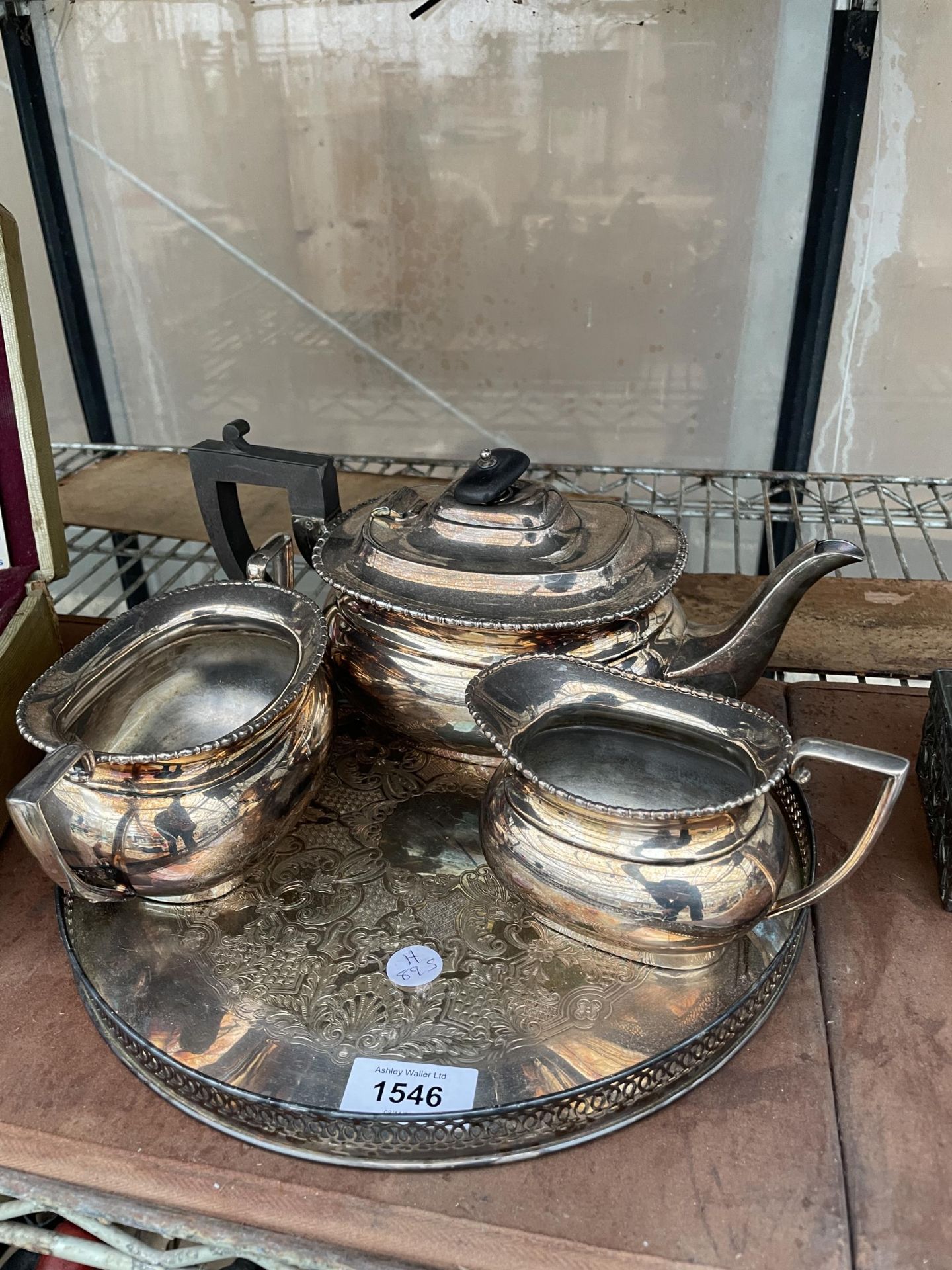 A SILVER PLATED TEA SERVICE TO INCLUDE A TRAY, TEAPOT, SUGAR BOWL AND MILK JUG