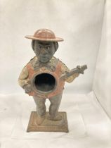 A VINTAGE CAST METAL FIGURE OF A MAN PLAYING THE GUITAR