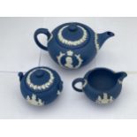 A 1953 WEDGWOOD NAVY JASPERWARE QUEEN ELIZABETH II & DUKE OF EDINBURGH COMMEMORATIVE THREE PIECE