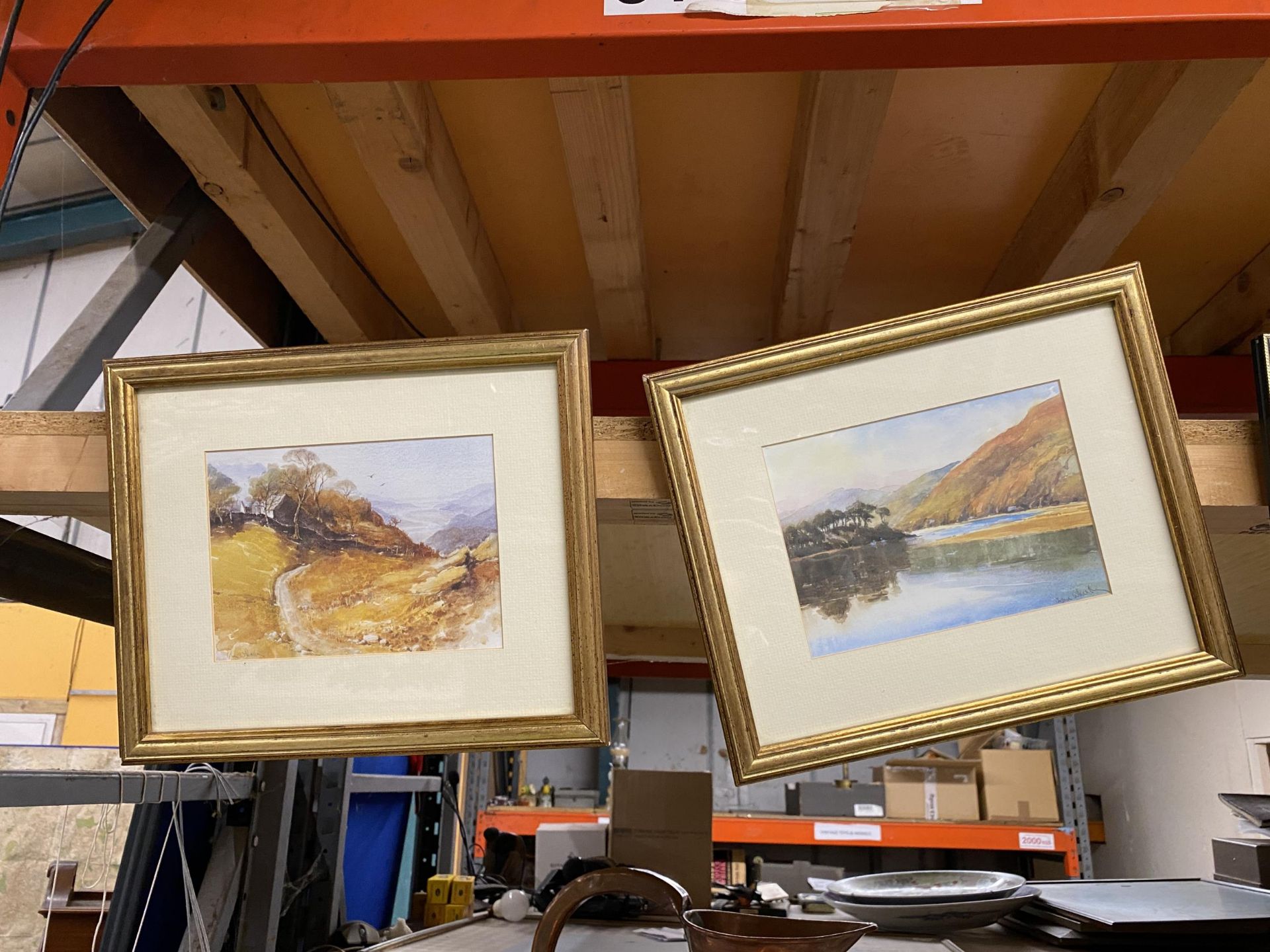 TWO GILT FRAMED WATERCOLOURS OF HILLSIDE AND LAKE SCENES, SIGNED WHALLEY