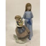 TWO FIGURES - LLADRO GIRL HOLDING FLOWERS AND A NAO GIRL IN A LONG BLUE DRESS