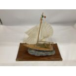 A MODEL OF A VINTAGE ITALIAN YACHT, ON A WOODEN PLINTH, WITH ENAMEL AND BRASS HULL, HEIGHT APPROX