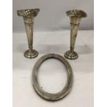 THREE HALLMARKED SILVER ITEMS - PAIR OF WALKER AND HALL BUD VASES AND AN OVAL PHOTO FRAME