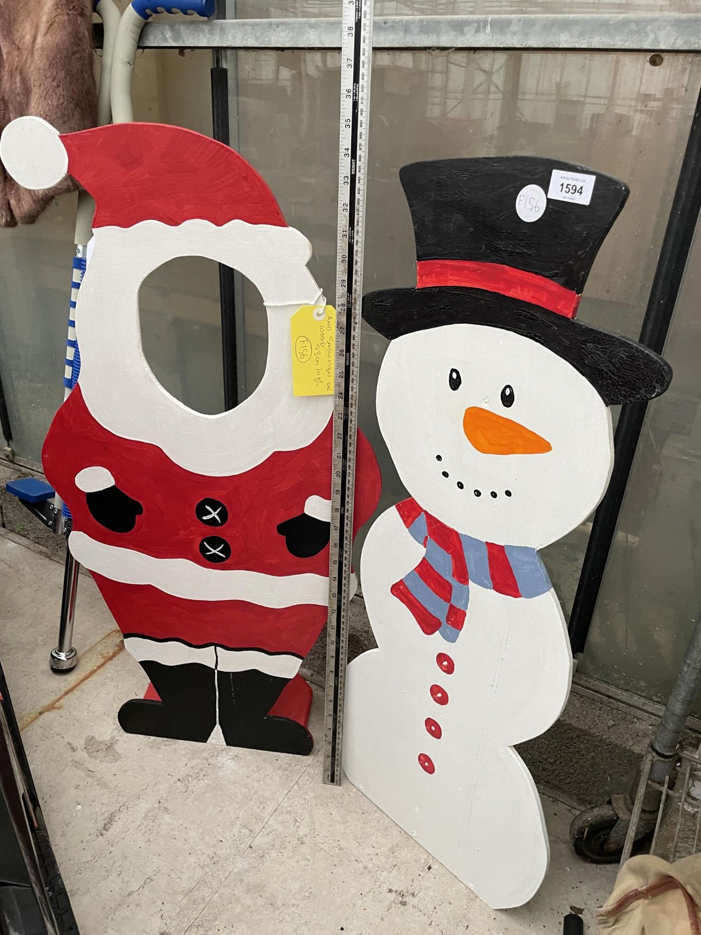A HAND PAINT SNOWMAN AND SANTA FIGURES WITH CUT OUT HOLE ON THE SANTA (H:93CM)