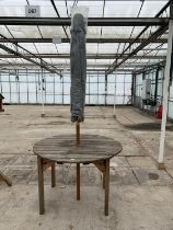 AN AS NEW EX DISPLAY CHARLES TAYLOR CIRCULAR TABLE WITH A GREY PARASOL + VAT