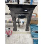 A SMALL CAST IRON FIRE SURROUND