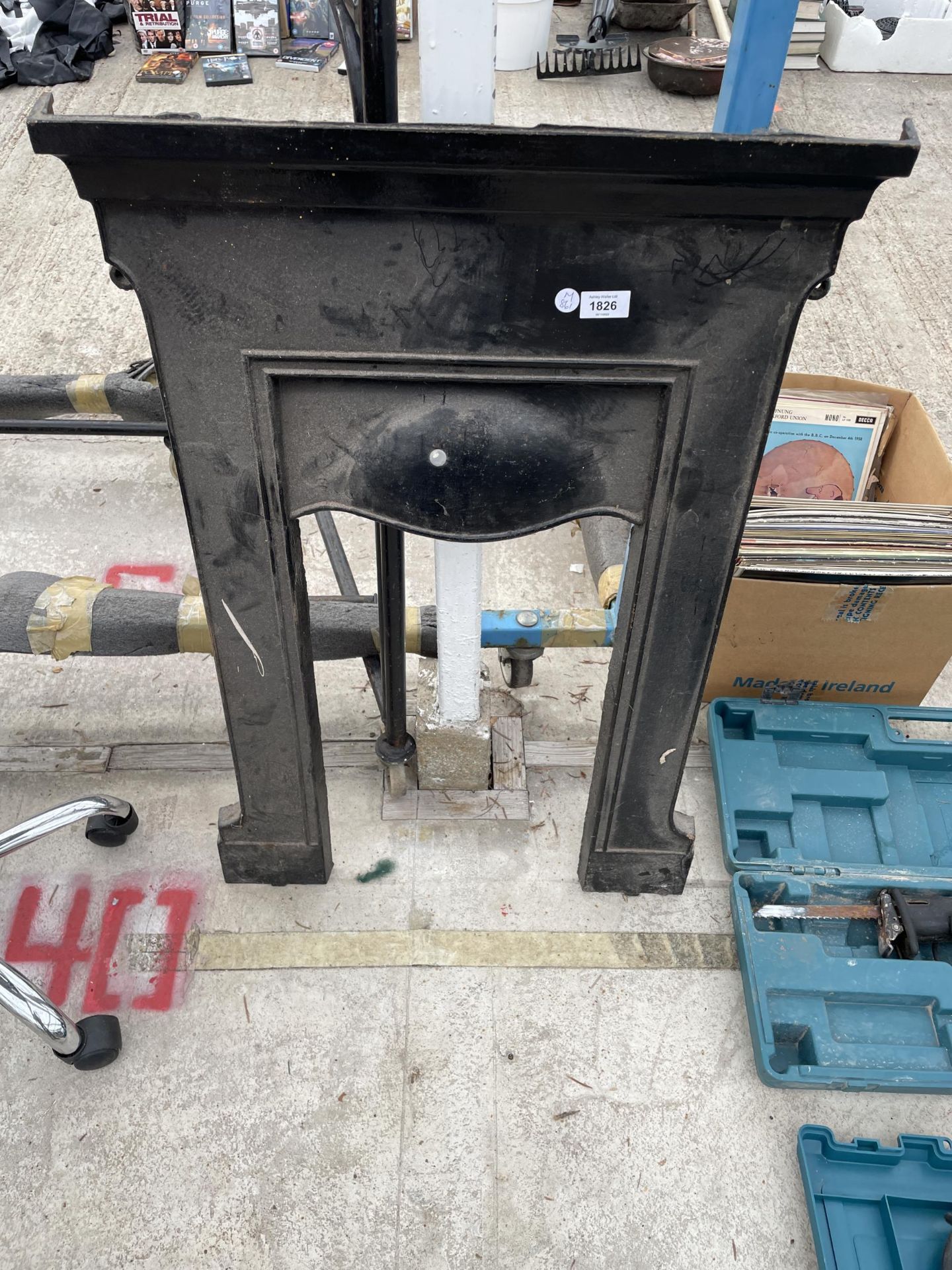 A SMALL CAST IRON FIRE SURROUND