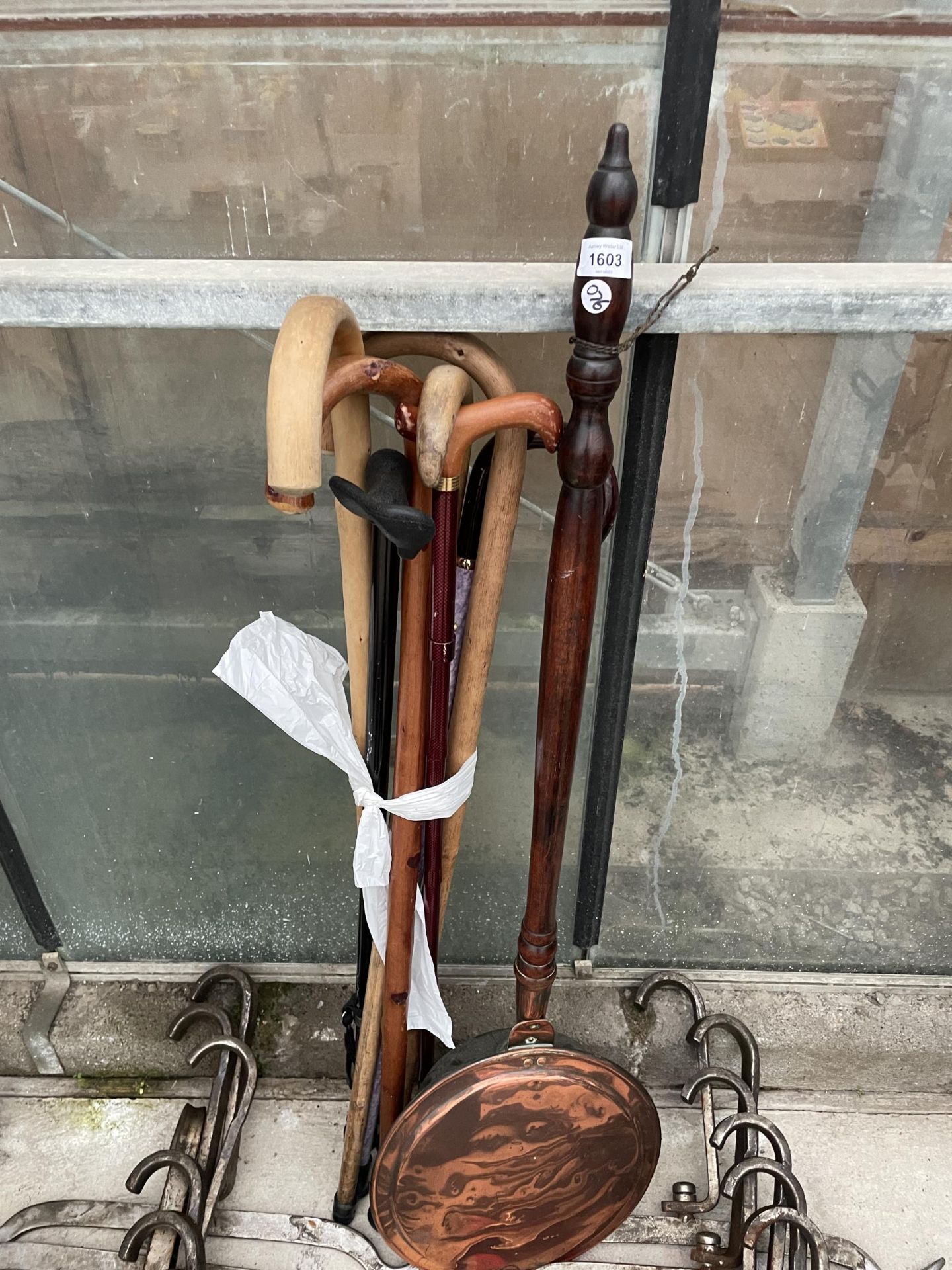 AN ASSORTMENT OF WALKING STICKS AND A COPPER BED WARMING PAN