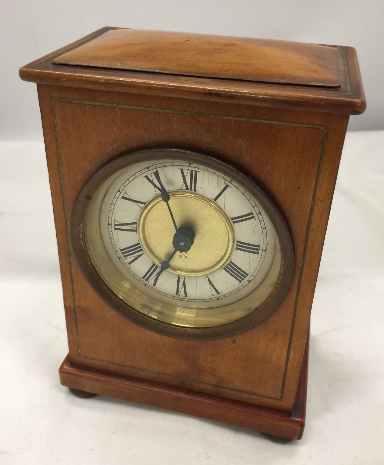 A VINTAGE FRUITWOOD MANTLE CLOCK WITH KEY