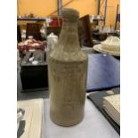 A VINTAGE J HEGINVBOTHAM, STALEY BRIDGE STONEWARE BOTTLE