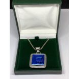 A BOXED SILVER NECKLACE WITH LARGE BLUE STONE PENDANT