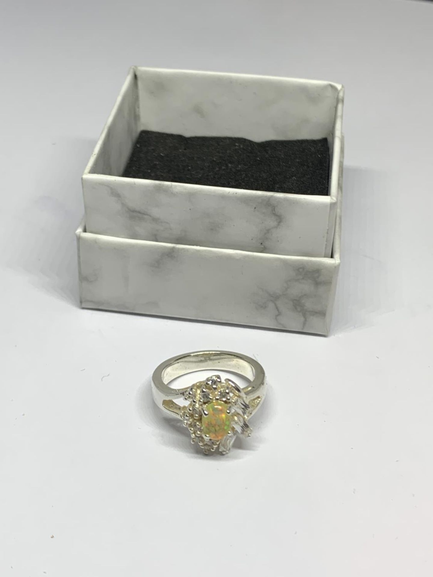 A BOXED SILVER AND OPAL RING