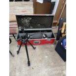 A STORAGE BOX WITH A TRIPOD WORK LIGHT AND A FURTHER TRIPOD CAMERA STAND