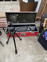 A STORAGE BOX WITH A TRIPOD WORK LIGHT AND A FURTHER TRIPOD CAMERA STAND