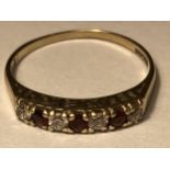 A 9 CARAT GOLD RING WITH THREE GARNETS AND FOUR CUBIC ZIRCONIAS IN LINE SIZE O/P