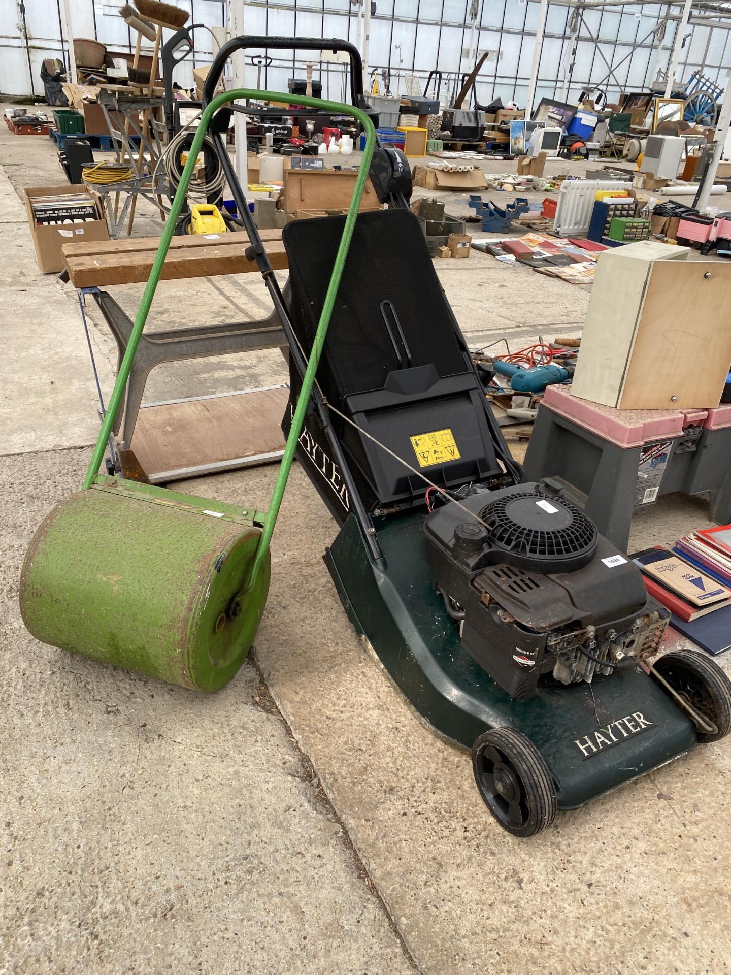 A HAYTER ROTARY LAWN MOWER WITH GRASS BOX AND A SMALL GARDEN ROLLER