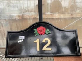 A CAST ALLOY NO.12 HOUSE SIGN WITH RED ROSE DETAIL