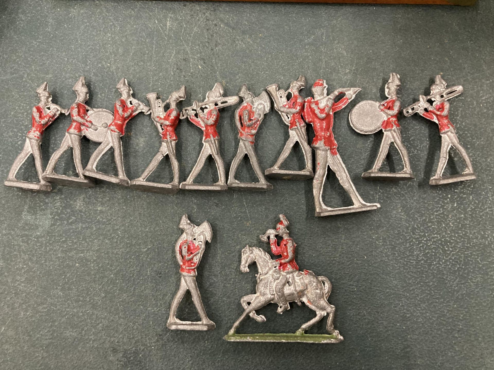 A VINTAGE 12 PIECE LEAD REDCOAT BRASS BAND