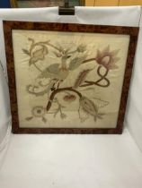 A WALNUT FRAMED VINTAGE SILK EMBROIDERY OF A BIRD AMONGST FLOWERS