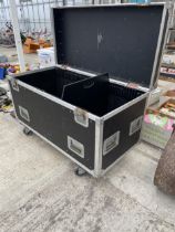 A LARGE FOUR WHEELED HARD CASED STORAGE BOX