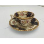 AN ANTIQUE COALPORT BLUE AND GILT Y3517 CUP AND SAUCER