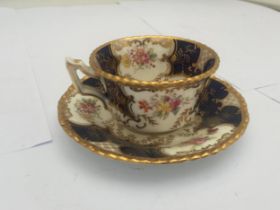 AN ANTIQUE COALPORT BLUE AND GILT Y3517 CUP AND SAUCER