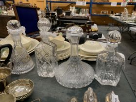 A GROUP OF FOUR CUT GLASS DECANTERS TO INCLUDE ROYAL DOULTON EXAMPLE AND SILVER PLATED DECANTER