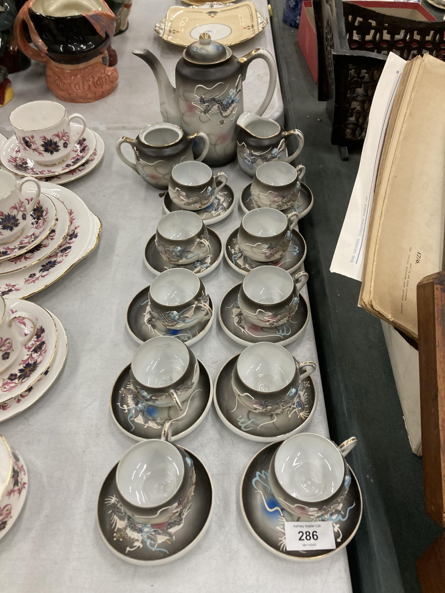 A JAPANESE 'KUTANI' CHINA COFFEE SET WITH DRAGON PATTERN AND TRANSLUCENT BASE TO THE CUPS WITH AN