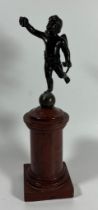A FRENCH BRONZE MODEL OF CUPID ON A RED MARBLE BASE, HEIGHT 23 CM
