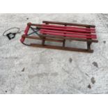 A VINTAGE WOODEN AND METAL BANDED SLEDGE