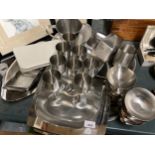A LARGE COLLECTION OF STAINLESS STEEL DINNER WARE TO INCLUDE GOBLETS, DISHES, SERVING TRAYS, ETC