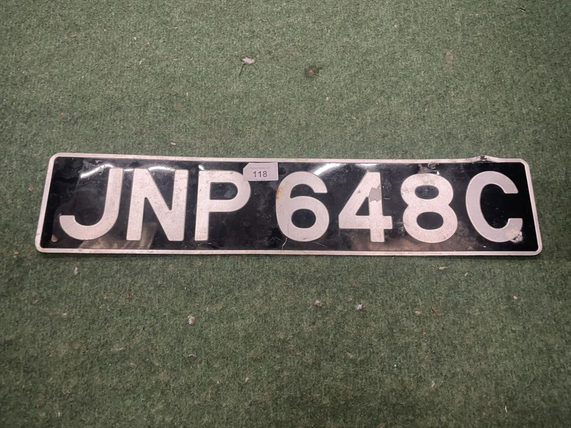 A VINTAGE DE-REGISTERED NUMBER PLATE - JNP 648C