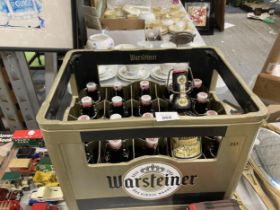 A PLASTIC CRATE OF RE-SEALABLE GERMAN BEER BOTTLES