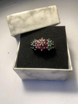 A BOXED COLOURED STONE RING