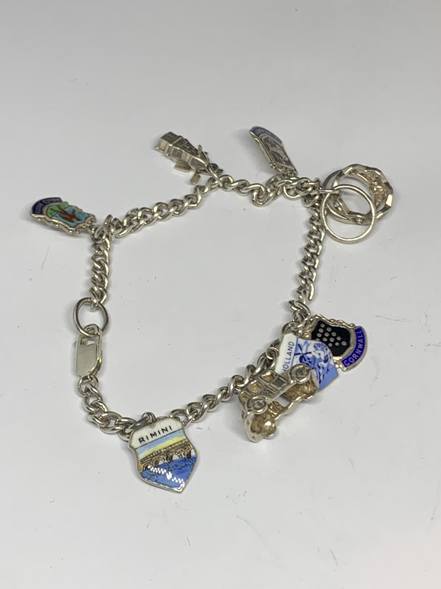 A SILVER CHARM BRACELET WITH SEVEN CHARMS