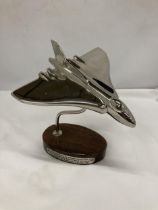 A CHROME VULCAN BOMBER ON WOODEN BASE