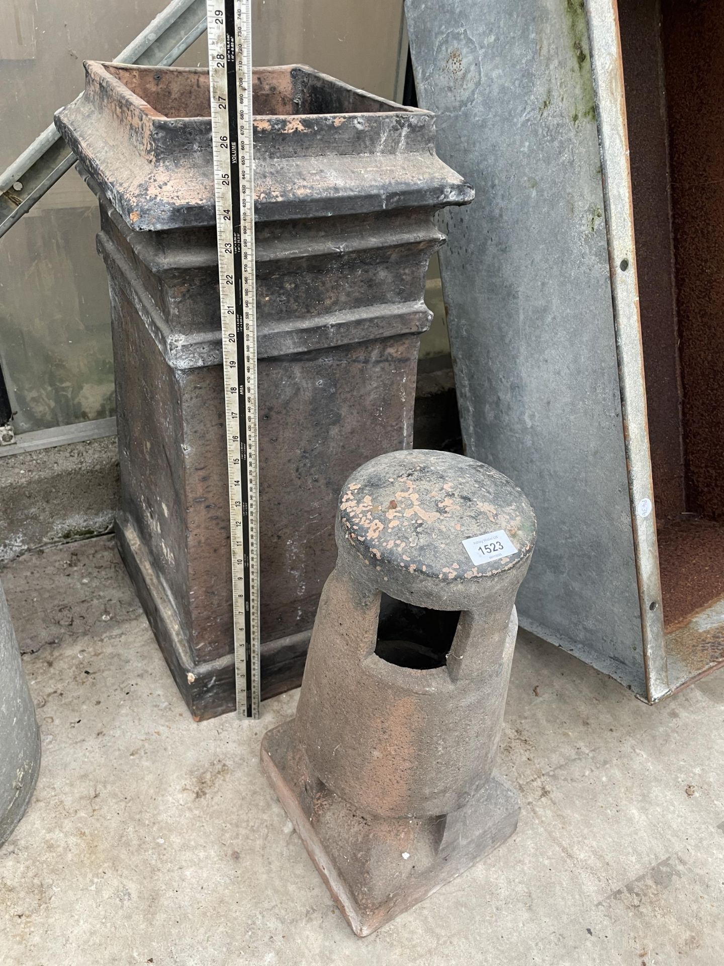 A DECORATIVE CHIMNEY POT AND A FURTHER CHIMNEY POT TOPPER